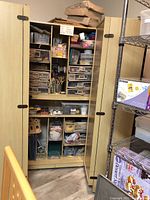Open front view showing interior with clear plastic drawers and fabric bins