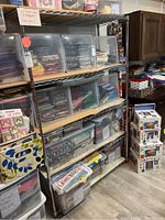 Left side view of one wire rack loaded with fabric bins, showing two particle board shelves inserted.