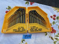 Open yellow plastic case showing 30 black Allen keys in two trays, marked as 15 piece inch size long arm series on left and 15 piece metric size short arm series on right.