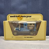 Side view of the 1912 Ford Model T toy truck inside its original Matchbox Models of Yesteryear packaging, showing blue body with Cerebos Table Salt graphics.