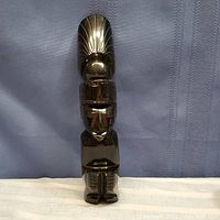 Full view of the carved obsidian figure showing height, shape and overall design.