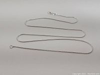 Image of 20 inch sterling silver chain necklace laid out showing full length and clasp.