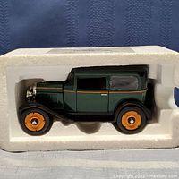 Die cast 1930 Chevrolet Coach model car inside original white styrofoam packaging showing right profile.