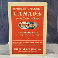 Front cover of Imperial Oil map, red and cream with illustration of Imperial Oil dealer.