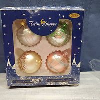 Front view of 4 mercury glass ornaments in original Trim Shoppe box showing all ornaments and exterior details