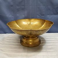 Solid brass pedestal bowl front view showing scalloped edge