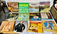 Full view of the 12 vintage country vinyl records spread out showing album covers with various artists and themes.
