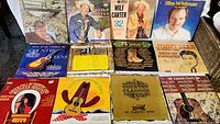 Top view of all 12 vinyl albums arranged with covers showing various country music artists and themes including Wilf Carter, Slim Whitman, Jimmy Dean.