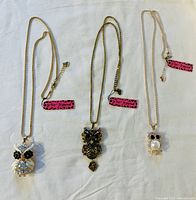 Three owl pendant necklaces by Betsey Johnson displayed on white background, showing full length and pendants.