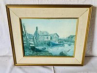 Wooden framed and matted print of a waterfront by Keirstead, showing boats and buildings on water, measuring 19.5 x 16 inches.