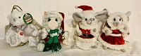 Group photo showing all four plush animated singing figures: white bear, white cat, Mr. Claus mouse, and Mrs. Claus mouse