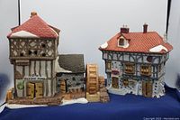Photo showing Blythe Pond Mill House with water wheel and Tutties Pub miniature buildings from Heritage Village's Dickens Village Series in very good condition.