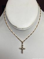 Full view of necklace displayed on mannequin showing rope chain and cross pendant.