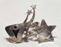 Front view of three unique sterling silver rings with star and geometric designs arranged facing forward.