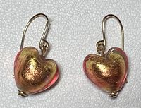 Front view of pink and gold Murano glass heart drop earrings with gold hooks.
