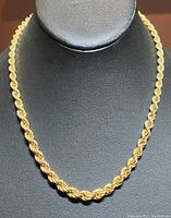 17 inch gold-toned thick rope chain necklace on black bust