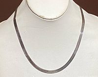 Front view of a 16-inch silver necklace on display bust, showing the chain's flat and smooth design.