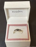 Pandora sterling silver ring displayed inside original branded box with pink trim and white padded interior.