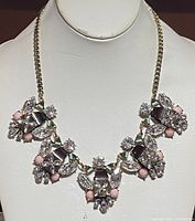 Front view of the chunky beaded crystal metal costume necklace showing metal chain and bead clusters.