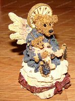 Angelica Bearstone limited edition stone resin figurine showing angelic bear holding smaller bears sitting on cloud base with wings and halo detail.