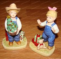 Front view of boy and girl Denim Days Holiday figurines showing detailed painting and decorations.