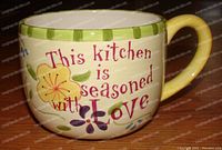 Close-up of the stoneware mug showing the text and floral design
