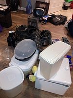 Overview of lot showing bread maker, crockpot, storage containers, warming pots, and other items.