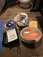 Full lot of paraffin wax bath, heated wax container, nail dryer, wax beads, and liners as seen on floor