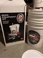 Kit box with Alfred's label and two large fermenter buckets.
