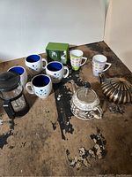 Full set of coffee and tea items including mugs, French press, tea kettles