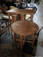 Photo showing the full set of one larger table and four smaller nesting tables stacked underneath.