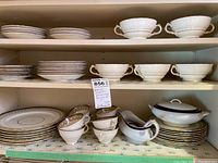 Wide view of Delphine China service on shelves showing stacks of plates, bowls, cups, saucers, gravy boat, covered bowl