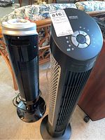 Two tower fans side by side, one Seville Classics and one Norma fan.