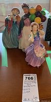 Three Royal Doulton figurines positioned together showing detail and style for identification.