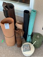 Full view of large rolls of leather remnants and crafting cords in various colors and textures.