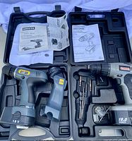 Two cordless drills in cases with manuals and drill bits, Nikota 2-in-1 and Craftsman 18V cordless drills.