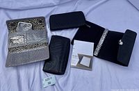 Four wallets arranged on white surface showing front and inside details.