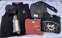 Overview of the entire lot showing vest, ball cap, steel water bottle, sweatshirts, and duffle bag