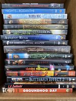 Stack of 16 DVD movie cases showing titles including Lord of the Rings, Michael Jackson, Mamma Mia!, and others