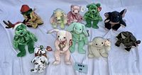 Group photo of all 11 small holiday-themed Beanie Babies plush animals displayed on white background, showing tags and colors