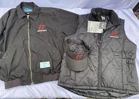 Photo of Thorncroft black fleece jacket, quilted vest, and sun visor laid out on white background.