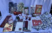 Photo of entire lot showing the variety of vintage Christmas items including paper cutouts, ornaments, gift bags, flowers, candles, and bows.