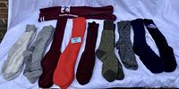Photo shows 10 pairs of winter and long socks including white, gray, maroon, orange, olive green, heathered gray, navy, and dark blue colors. Socks appear warm and suitable for winter wear.