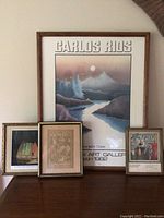 Full view of four framed art prints arranged on a surface showing sizing and condition.