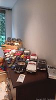 Overview of 24 assorted diecast model cars displayed on a table