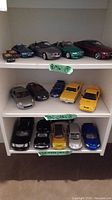 Four BMW models displayed on white shelf