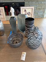 Full view of all five pieces on table with framed horse art background