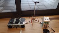Photo showing Yamaha CRX-040 sound system, remote control, cables, Yorkville guitar stand, and boxed Blue Yeti microphone.