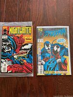 Photo showing Nightwatch and Spider-Man comics side by side, featuring Venom on their covers.