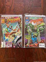 Photo showing two Spider-Man Exiled comics titled 'Shadows of the Past' and 'Vultures Prey' with clear protective sleeves and backer-boards.